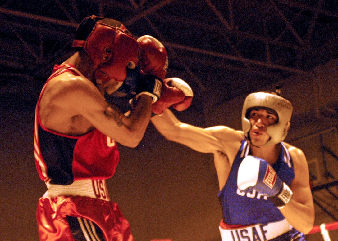 LACKLAND AIR FORCE BASE, Texas -- Senior Airman Ramon Castro delivers a straight right hand to Senior Airman Michael Walker from Minot Air Force Base, N.D.  Airman Castro, from Hurlburt Field, Fla., captured the 152-pound welterweight title.  (U.S. Air Force photo by Alan Boedeker)
