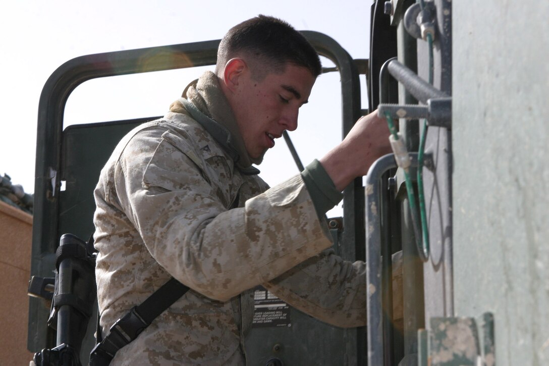 JORDANIAN BORDER, Iraq -- Lance Corporal Ben Gunderson a 20-year-old Gaylord, Mich. native and motor transportation operator with 2nd Marine Division, Headquarters Battalion, Truck Co., climbs into the cab of his 7-Ton Truck for a pre-convoy inspection, March 26.  Gunderson is a 2002 Gaylord High School graduate and veteran of two tours in Operation Iraqi Freedom.  U.S. Marine Corps photo by Sgt. Stephen D'Alessio (RELEASED)