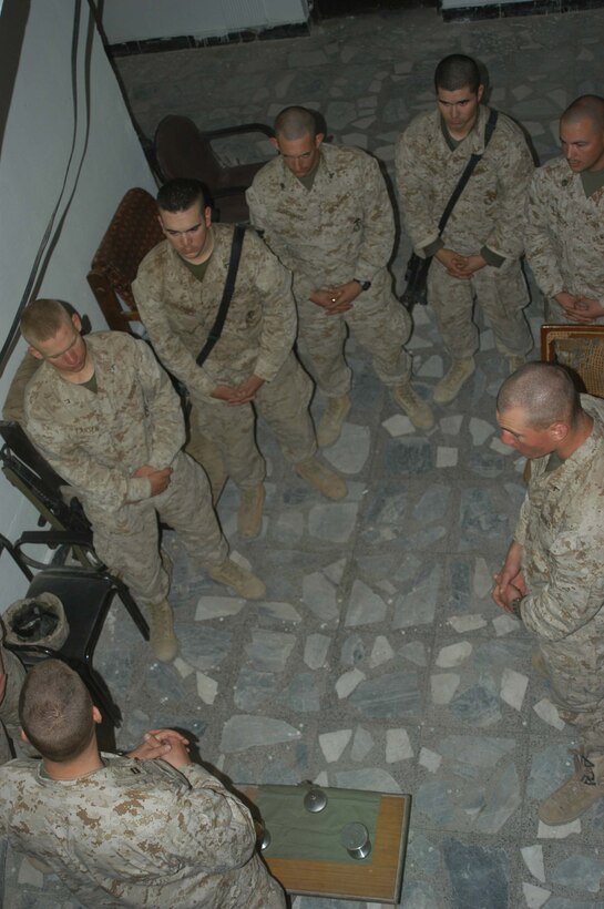 AR RAMADI, Iraq (March 27, 2005) - Navy Lt. Aaron T. Miller, chaplain for 1st Battalion, 5th Marine Regiment, delivers an Easter message to Marines with Company A inside the Government Center building here. The 32-year-old man of God from Redlands, Calif., visited Marines from the infantry battalion's five companies of whom he preached a hasty Easter service and served Holy Communion to. The effort, which lasted more than six hours, required Miller to travel to seven different places in the city where Marines are serving. Photo by Cpl. Tom Sloan