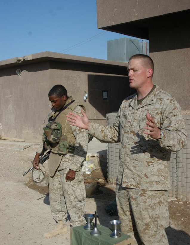 AR RAMADI, Iraq (March 27, 2005) - Navy Lt. Aaron T. Miller,(right) chaplain for 1st Battalion, 5th Marine Regiment, and his religious program specialist, 22-year-old Petty Officer 3rd Class Ternandez M. Calloway of Birmingham, Ala., pray during Easter service at Camp Snake Pit here. The 32-year-old man of God from Redlands, Calif., visited Marines from the infantry battalion's five companies of whom he preached a hasty Easter service and served Holy Communion to. The effort, which lasted more than six hours, required Miller to travel to seven different places in the city where Marines are serving. Photo by Cpl. Tom Sloan
