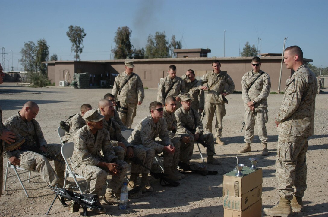 AR RAMADI, Iraq (March 27, 2005) - Marines with Company C, 1st Battalion, 5th Marine Regiment, listen attentively to Navy Lt. Aaron T. Miller, the infantry battalion's chaplain, conduct Easter service at Camp Snake Pit here. The 32-year-old man of God from Redlands, Calif., visited Marines from the infantry battalion's five companies of whom he preached a hasty Easter service and served Holy Communion to. The effort, which lasted more than six hours, required Miller to travel to seven different places in the city where Marines are serving. Photo by Cpl. Tom Sloan