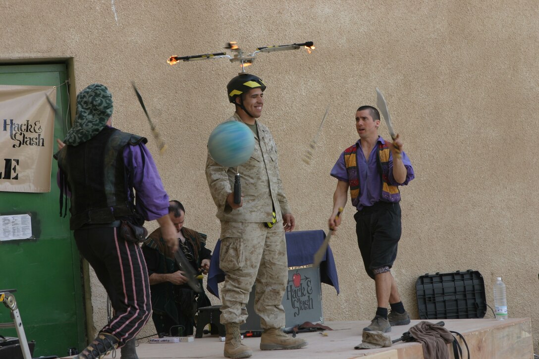 CAMP AL QA'IM, Iraq (March 27, 2005)- A Marine is the subject of this comedy routine here. The Hack and Slash comedy tour landed in Al Qa'im to bring laughter to the Marines of 3rd Battalion, 2nd Marine Regiment on Easter Sunday. The tour features Spencer "Slash"  Humm and John "Hack" Davis and Todd "Ripe Zucchini" Key and juggler Dan Thurmon. Operation Swashbuckle was brought to the Marines and sailors by Armed Forces Entertainment. Official U.S. Marine Corps photo by Lance Cpl. Lucian Friel (RELEASED)