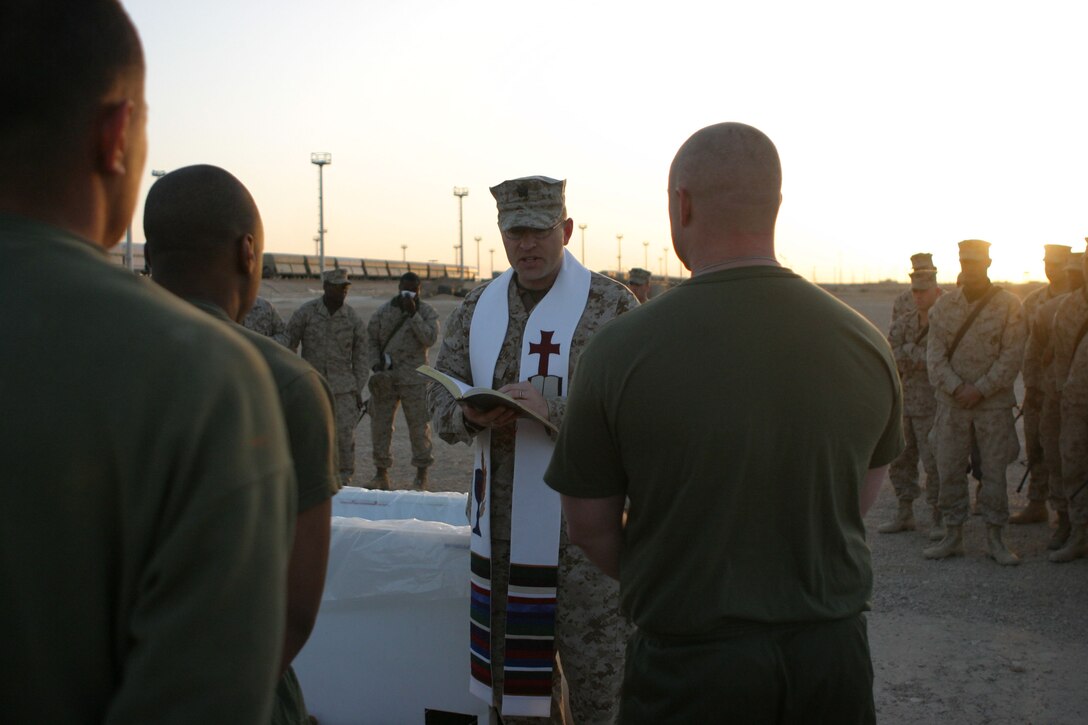 CAMP AL QA'IM, Iraq (March 27, 2005)-  Before Pfc. Sean M. Henry, a mortar man with Company K, 3rd Battalion, 2nd Marine Regiment is baptized. The Bn. Chaplain LT. John Anderson reads a scripture from the Holy Bible. The Queens, N.Y., native joined the Corps over a year ago and this is his first deployment to Iraq. Henry, 19, a 2003 August Martin High School decided to be baptized the day before Easter and described his feelings while being baptized as feeling the purity come over him. The sunrise service was to signify the rising of the son of God as the Sun rises in the horizon. Official U.S. Marine Corps photo by Lance Cpl. Lucian Friel (RELEASED)