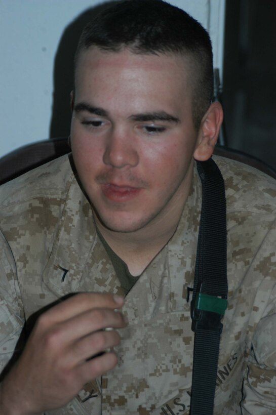 AR RAMADI, Iraq (March 27, 2005) - Nineteen-year-old Pfc. Rick R. Blakely, a rifleman with 3rd Squad, 4th Platoon, Company A, 1st Battalion, 5th Marine Regiment, takes Holly Communion at the Government Center building here Easter Sunday. The infantry battalion's chaplain, Navy Lt. Aaron T. Miller, conducted a hasty, 15-minute Easter service for Blakely and other Company A Marines. Though the Easter celebration wasn't the same as Blakely is used to back home in Prescott, Mich., the 2004 Whittemore High School graduate said it would be one of his most memorable. Photo by Cpl. Tom Sloan