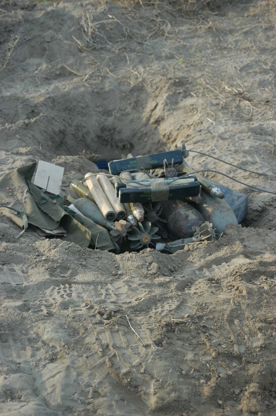 AR RAMADI, Iraq (April 26, 2005) -Marines with 4th Platoon, Company A, 1st Combat Engineer Battalion, discovered seven, large weapons caches buried on farmland on the southern outskirts of the city here. The engineers found 15 AK-47s; 12 bolt action rifles; three RPK machine guns; three rocket propelled grenade launchers; 200 60 mm shells, 100 82 mm shells; 20 120 mm shells; 10 155 mm shells; 40 pounds of P-C4 explosives; 30 hand grenades and 50 52 mm high explosive anti-tank missiles during their mission that had them trudging through the fields for more than 16 hours. The blast masters destroyed the weapons caches with controlled detonations so insurgents can no longer use them against coalition forces. Photo by Cpl. Tom Sloan