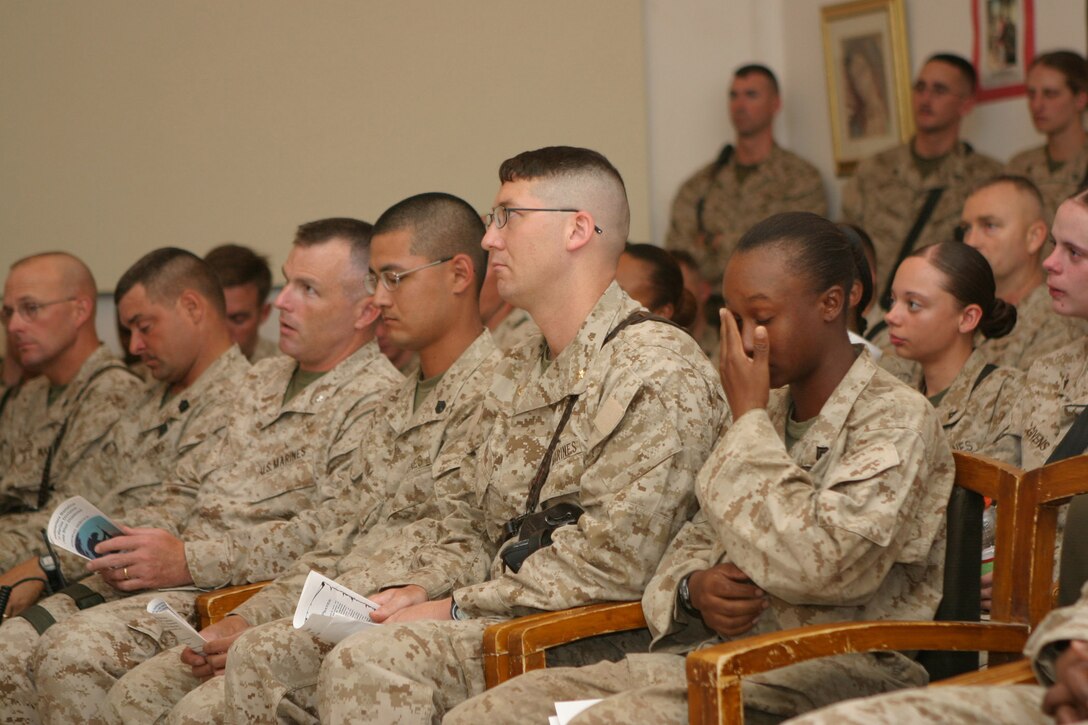 CAMP BLUE DIAMOND, AR RAMADI, Iraq - Corporal Millareisha Q. Dixon, an administration clerk here, mourns in the camp's chapel during a memorial service, June 27, for her best friend, Cpl. Holly Charette, a 21-year-old from Cranston, R.I., who deployed here earlier this year with the 2nd Marine Division for Operation Iraqi Freedom.  Charette was killed in a suicide car-bombing when her convoy was struck just a few days earlier.  U.S. Marine Corps photo by Sgt. Stephen D'Alessio (RELEASED)