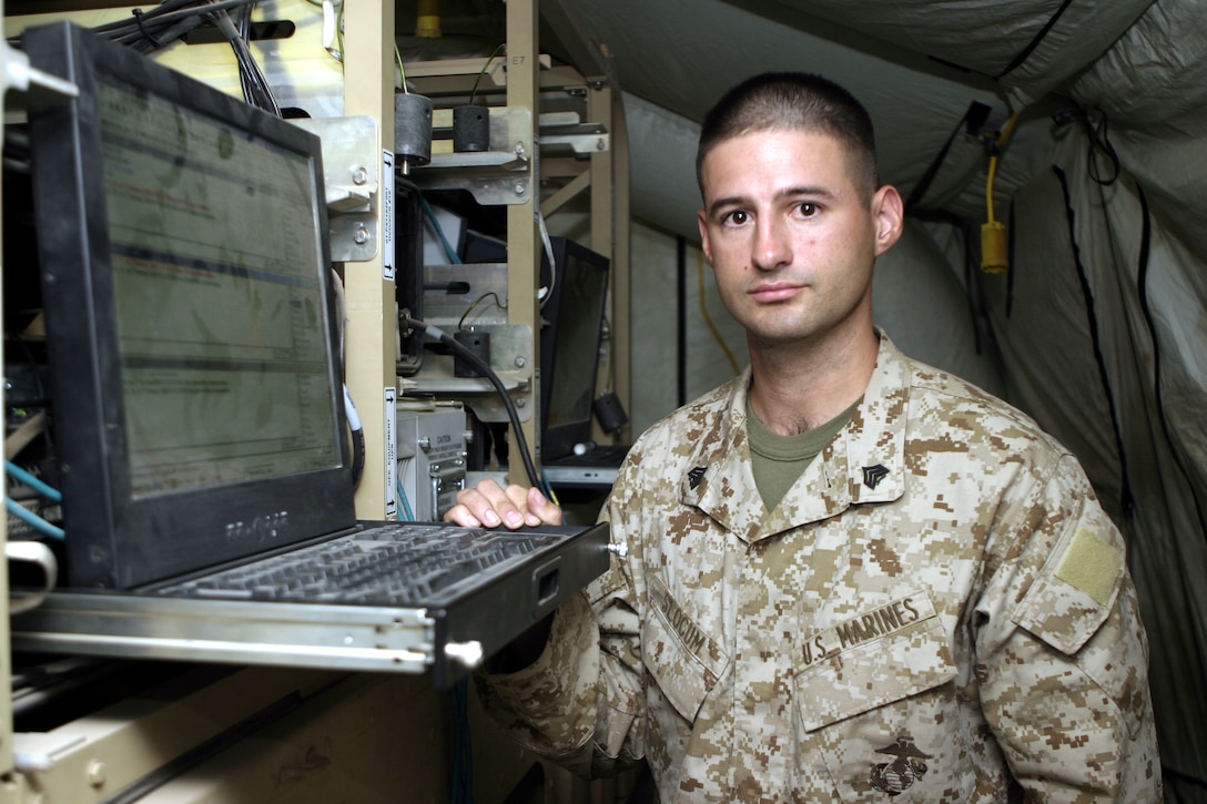 CAMP BAHARIA, Iraq - Sgt. David Slocum, 1st Battalion, 6th Marine Regiment data network specialist, helps his battalion's infantrymen troubleshoot their Enhanced Position Location Reporting System chat systems.  The 30-year-old Murfreesboro, Tenn. native's unit uses EPLRS chat laptop workstations to communicate with different bases throughout the area and transmit tactical data.
