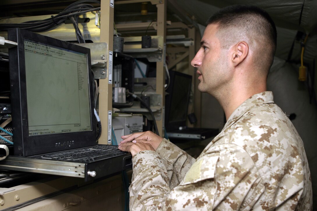 CAMP BAHARIA, Iraq - Sgt. David Slocum, 1st Battalion, 6th Marine Regiment data network specialist, types on an Enhanced Position Location Reporting System chat workstation.  The 30-year-old Murfreesboro, Tenn. native's unit uses EPLRS chat laptop workstations to communicate with different bases throughout the area and transmit tactical data.