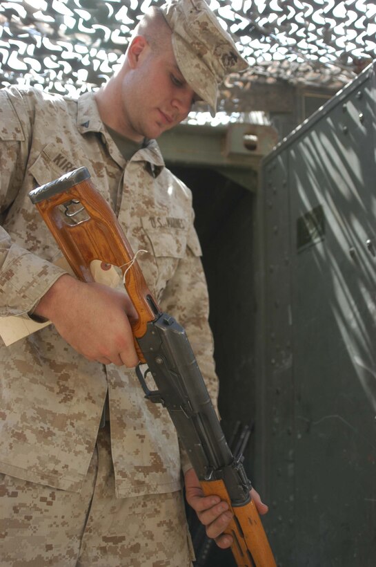 CAMP HURRICANE POINT Ar Ramadi, Iraq (July 20, 2005) - Lance Cpl. Adam J. Kircher, an armorer with Headquarters and Service Company, 1st Battalion, 5th Marine Regiment, inspects an enemy weapon that was recently seized by Marines in the city. The 22-year-old from Omaha, Neb., and six other Marines work at the armory and are responsible for keeping all the Camp Pendleton, Calif., -based infantry battalion's warriors armed with fully operational weapons so they can complete their mission on the urban battlefield. Photo by: Cpl. Tom Sloan