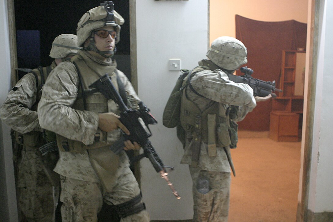 SAQLAWIYAH, Iraq - Sgt. Daniel Kachmar, 2nd squad leader, 4th Platoon, Company A, 1st Battalion, 6th Marine Regiment, and his Marines search a home here July 27 during Operation Hard Knock.  Company A Marines searched dozens of houses throughout the small township outside Fallujah, looking for weapons, explosives and insurgent activity while gathering census data on the populace there.  The Marines apprehended one suspected insurgent supporter.