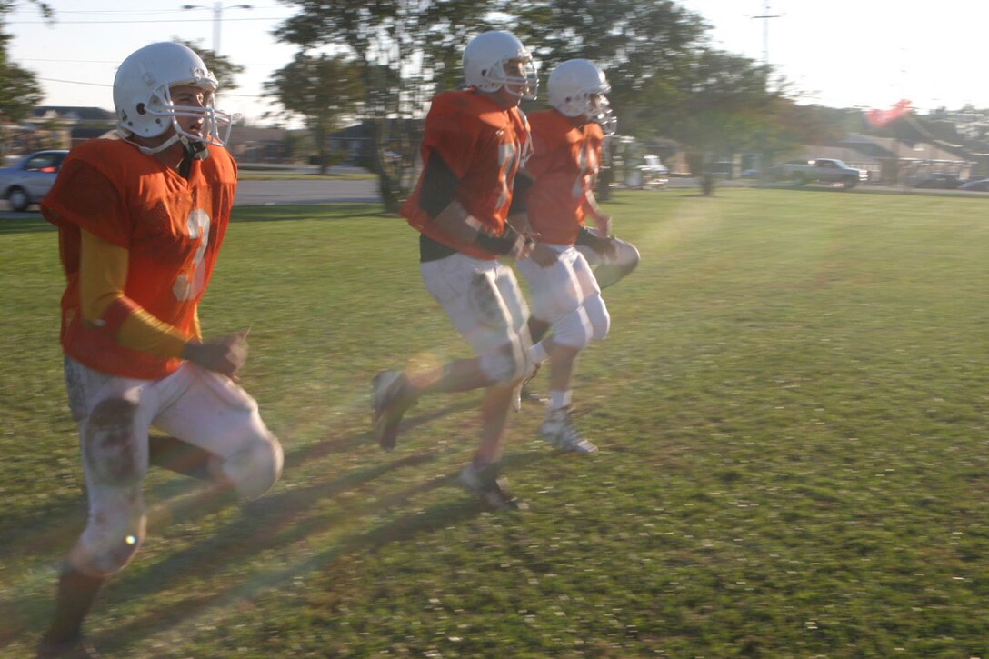 MARINE CORPS BASE CAMP LEJEUNE, N.C. (Oct. 27, 2005)- After their victory over the 4th Marine Expeditionary Intramural Football team, the players of the 2nd Marine Division Headquarters team run through warm-ups before practice here today. (Official U.S. Marine Corps photo by Lance Cpl. Lucian Friel (RELEASED)