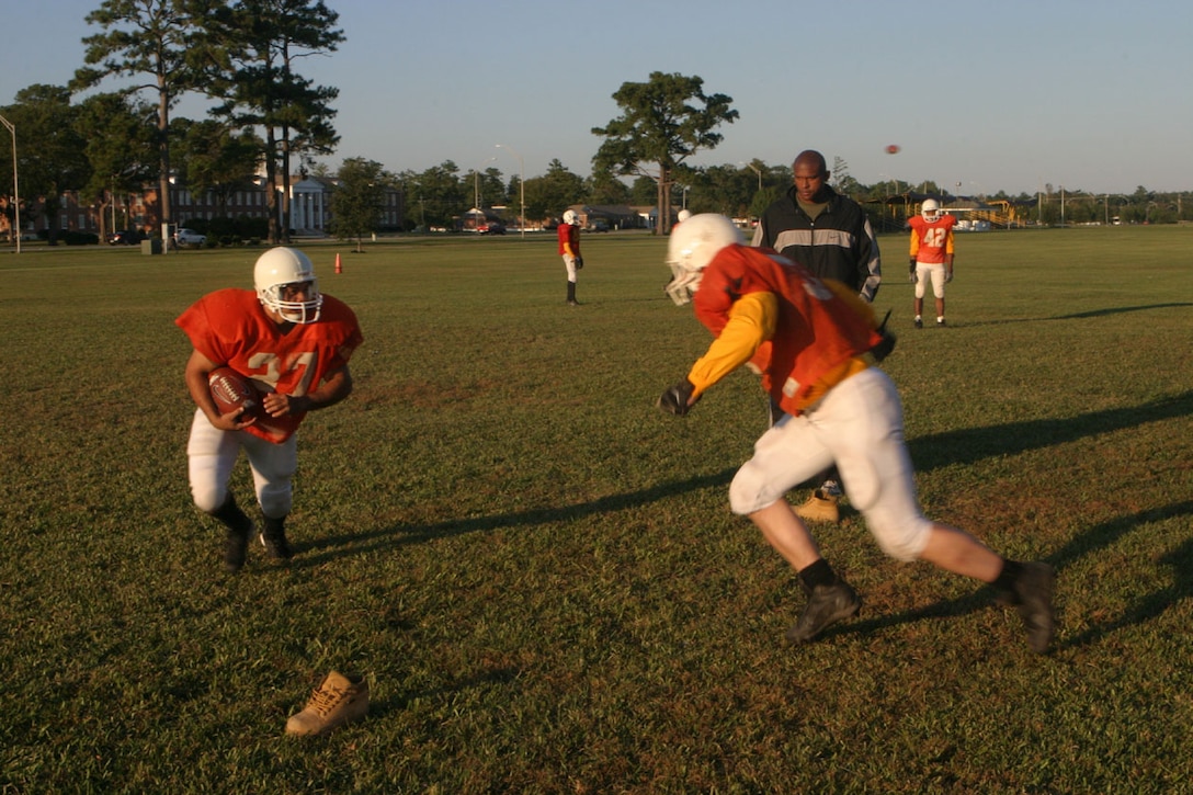 MARINE CORPS BASE CAMP LEJEUNE, N.C. (Oct. 27, 2005)- After their victory over the 4th Marine Expeditionary Intramural Football team, the players of the 2nd Marine Division Headquarters team run through warm-ups before practice here today. (Official U.S. Marine Corps photo by Lance Cpl. Lucian Friel (RELEASED)