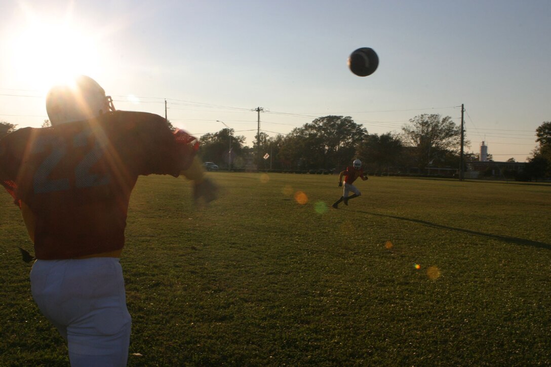 MARINE CORPS BASE CAMP LEJEUNE, N.C. (Oct. 27, 2005)- The Division Intramural Tackle Football team quarterback, Hospital Corpsman 3rd Class Michael "Doc" Robinson, a native of Enterprise, Ala., throws a pass to one of his recievers at practice here today. The division team is confident that they will end the season undefeated, especially after winning their opening game against the 4th Marine Expeditionary Brigade team, 12-6. (Official U.S. Marine Corps photo by Lance Cpl. Lucian Friel (RELEASED)