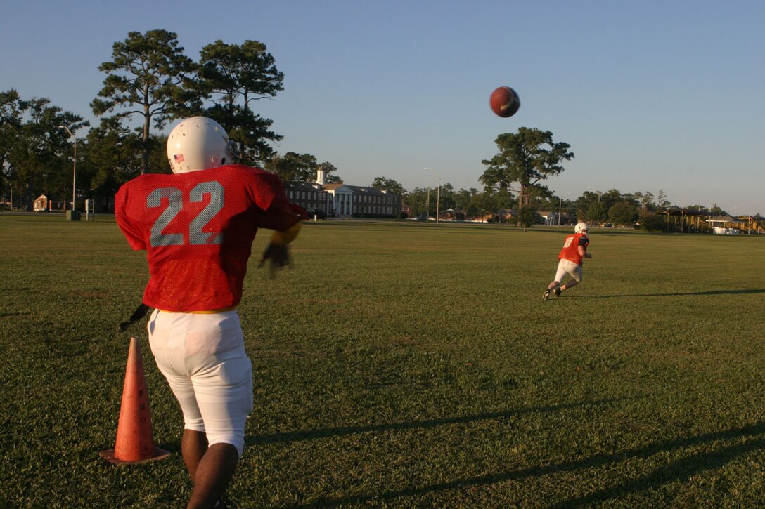 MARINE CORPS BASE CAMP LEJEUNE, N.C. (Oct. 27, 2005)- The Division Intramural Tackle Football team quarterback, Hospital Corpsman 3rd Class Michael "Doc" Robinson, a native of Enterprise, Ala., throws a pass to one of his recievers at practice here today. The division team is confident that they will end the season undefeated, especially after winning their opening game against the 4th Marine Expeditionary Brigade team, 12-6. (Official U.S. Marine Corps photo by Lance Cpl. Lucian Friel (RELEASED)