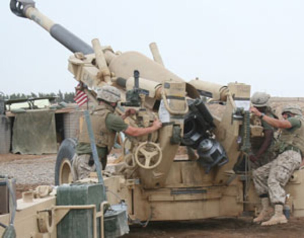 Marines of Alpha Battery, 1st Battalion, 10th Marine Regiment, 2nd Marine Division, prepare an M198 medium-towed Howitzer for a shot. Alpha Battery provides Camp Fallujah and other units in the vicinity with artillery support.