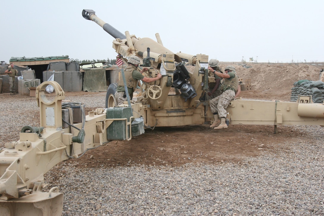 Marines of Alpha Battery, 1st Battalion, 10th Marine Regiment, 2nd Marine Division, prepare an M198 medium-towed Howitzer for a shot. Alpha Battery provides Camp Fallujah and other units in the vicinity with artillery support.