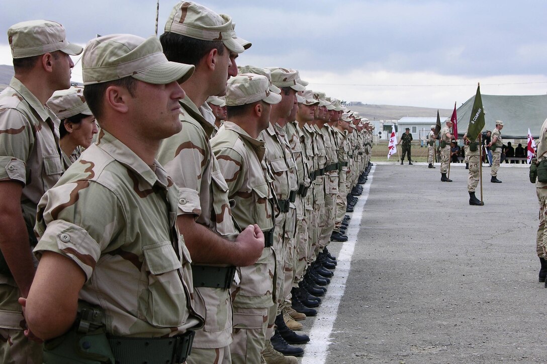 Republic of Georgia 22nd Light Infantry Battalion soldiers, stand at ease in the opening ceremony of the Georgia Sustainment and Stability Operations Program Phase II Bravo Aug. 27, in Krtsansi, Republic of Georgia.  This third group of Georgian soldiers will benefit from improvements made upon the pattern set in training the 21st and 23rd Light Infantry Battalions.  The 22nd Battalion's 17-week training will consist primarily of ground combat skills and tactics, such as marksmanship, first aid, urban operations and search techniques related to their future service in Iraq.