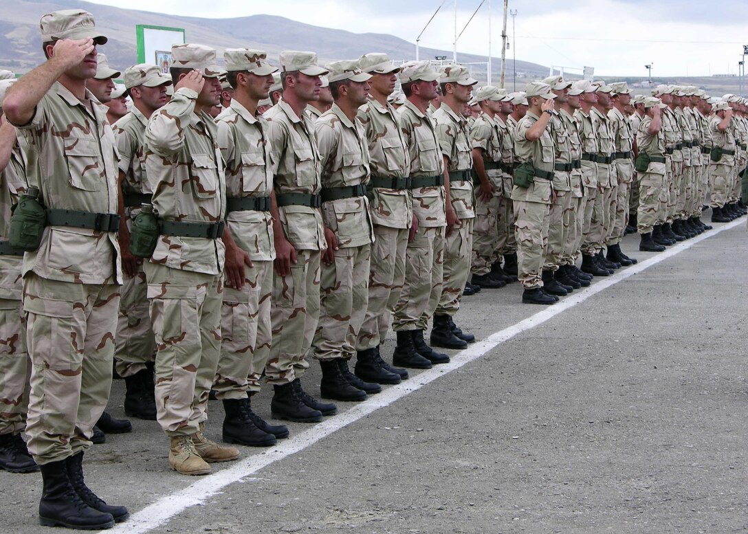 Republic of Georgia 22nd Light Infantry Battalion soldiers salute for the U.S. and Georgian national anthems during the Georgia Sustainment and Stability Operations Program Phase II Bravo opening ceremony Aug. 27, at Krisanisi, Republic of Georgia.  The GSSOP assists Georgia, a U.S. partner in the Global War on Terrorism, in providing capable, trained military units to sustain their contribution to the effort in Iraq.