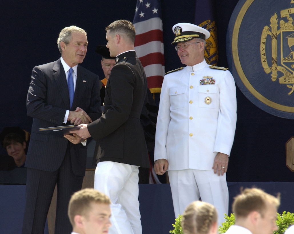 050527-N-6077T-019 Annapolis, Md. (May 27, 2005) - President George W. Bush congratulates Midshipman Steven W. Coulon, from Tucson, Ariz., Naval Academy class of 2005, during commencement and commissioning ceremonies at Navy-Marine Corps Memorial Stadium.  Coulon was commissioned a 2nd Lt. in the Marine Corps.  2nd Lt. Coulon first entered the Navy through the enlisted nuclear field program and was later accepted to the Naval Academy.  President Bush was in attendance to address and congratulate the nine-hundred and seventy-six graduates.  During graduation, each Midshipman receives a commission as an Ens. in the Navy, or 2nd Lt. in the Marine Corps.  U.S. Navy photo by Photographer's Mate 1st Class Kevin H. Tierney. (RELEASED BY FLEET IMAGING COMMAND PACIFIC)