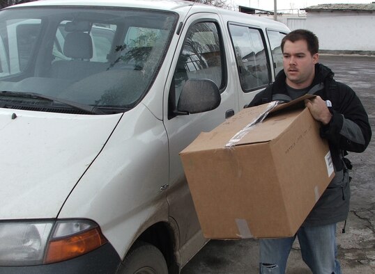 KARSHI, Uzbekistan -- First Lt. Steven Lawhun carries a box of donated clothing and shoes to an orphanage here Jan. 22.  Visits like these are part of an ongoing humanitarian assistance program to Uzbek orphanages.  Lieutenant Lawhun is deployed to the 416th Air Expeditionary Group at nearby Karshi-Khanabad Air Base.  He is from Moody Air Force Base, Ga.  (U.S. Air Force photo by Tech. Sgt. Scott T. Sturkol)