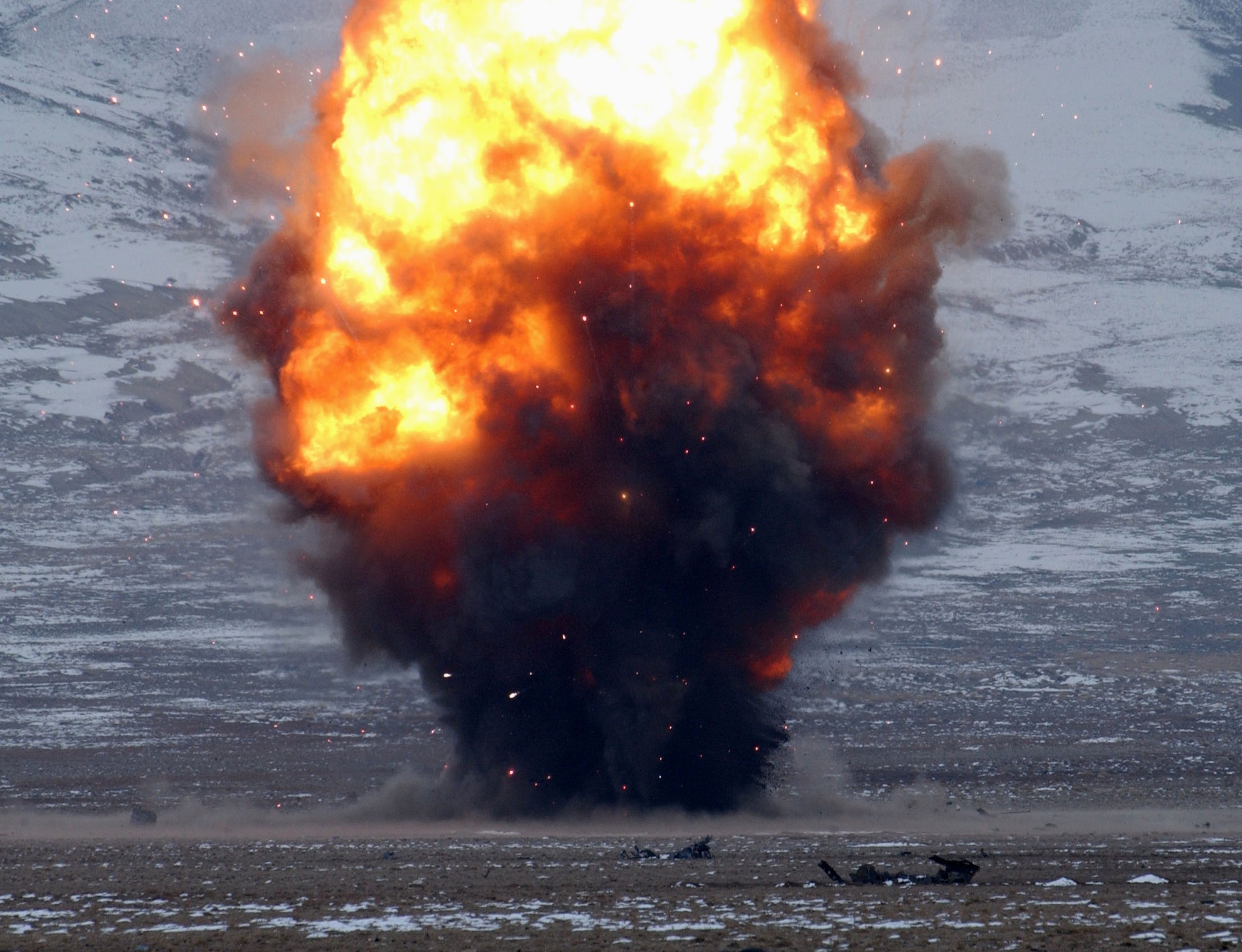 BAGRAM AIR BASE, Afghanistan -- More than 1,000 pounds of explosives light up the sky near here Jan. 23, as 455th Expeditionary Civil Engineer Squadron Explosive ordnance disposal Airmen destroy everything from small arms, aircraft ammunition and rockets, to Howitzer casings, large projectiles, rifle grenades and anti-tank mines.  (U.S. Air Force photo by Capt. Catie Hague) 