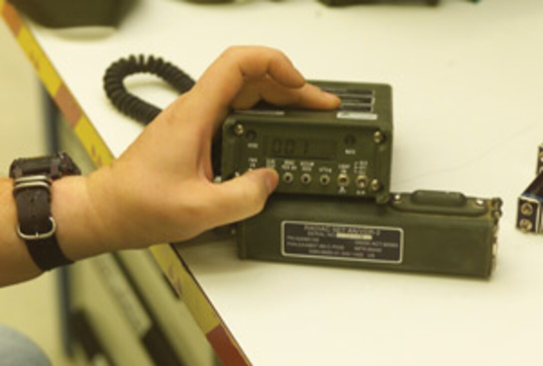 Lt. Scott Kriss, Branch Medical Clinic flight surgeon, reads the injury card of Sgt. Jason Allen, Headquarters and Headquarters Squadron mess hall quality assurance, during the annual Branch Medical Clinic mass casualty drill at the station clinic Oct. 20.