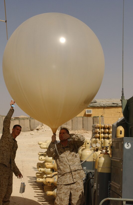 Cpl. Todd D. Patrick, 22, from Median, Ohio, and Lance Cpl. Allan J. Bourquin, 21, from Brocton, N.Y. inflate a weather balloon aboard Al Qaim, Iraq.  The balloon will be released into the atmosphere, sending data back to observers.  This information relates to the upper atmosphere, and makes it possible to forecast different weather fronts that may affect the region.  This information is important to the pilots who use this location as a base of operations.  These Marines are part of Marine Wing Support Squadron 271 from Cherry Point, N.C.  This forward operating base acts as a forward arming refueling point for aircraft in the region.