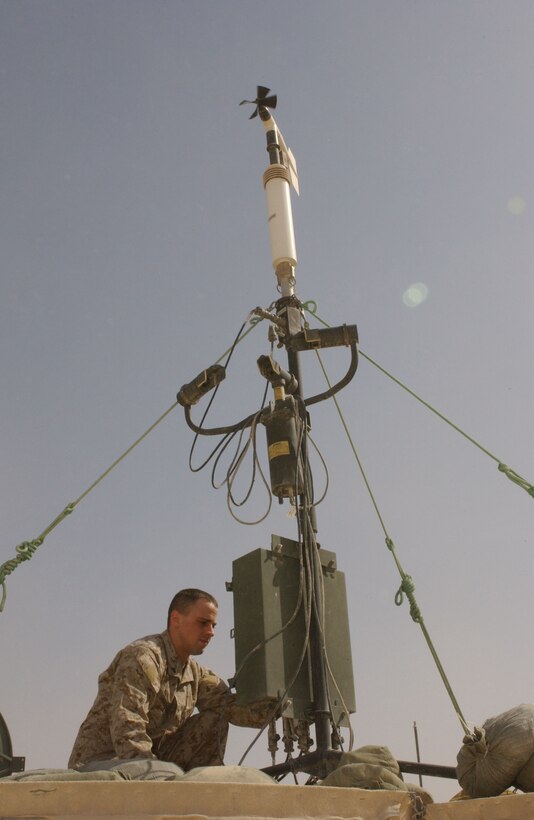 Cpl. Tony L. Shaffer, 21, from Cincinnati, Ohio, checks the installation of the local remote sensors at his unit's weather station aboard Al Qaim, Iraq.  This equipment provides observers and forecaster with surface data for windspeed, direction, temperature, dew point and air pressure.  This information is important to the pilots who use this location as a base of operations.  These Marines are part of Marine Wing Support Squadron 271 from Cherry Point, N.C.  This forward operating base acts as a forward arming refueling point for aircraft in the region.