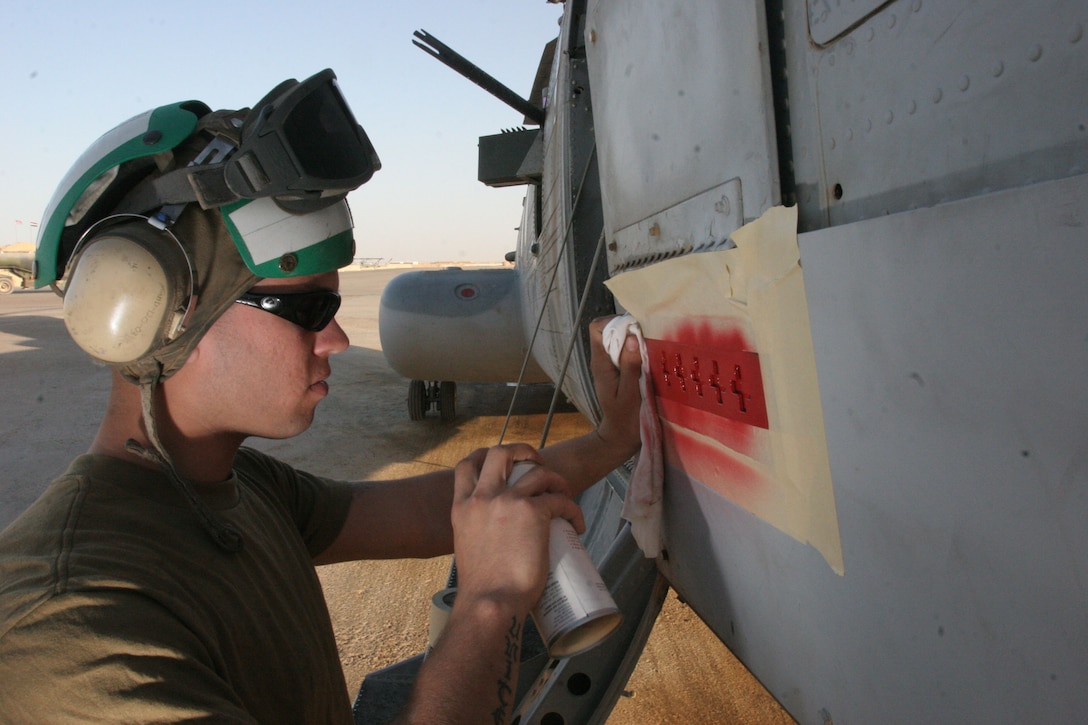 Marine Medium Helicopter Squadron 161?s tradition of painting crosses on their aircraft after successful urgent causality evacuations started during the Korean War. Lance Cpl. Daniel J. Burman, an airframes technician with HMM-161, continues in that tradition as he paints a red cross on a CH-46 Sea Knight at Al Taqaddum, Iraq.