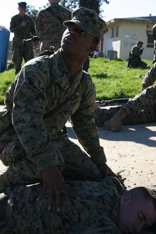 050119-M-4224F-001 MARCH AFB MORENO VALLEY, Calif.- Pfc. Jarius Hardnett, 19, an Atlanta native and a radio operator with 3rd Battalion, 2d Marine Regiment searches Lance Cpl. Brian Nelson during security and stabilzations operations Jan. 19. The training was the last opportunity for the 2003 McNair High School graduate to prepare for deployment to Iraq. U.S. Marine Corps photo by Lance Cpl. Lucian Friel (RELEASED)
