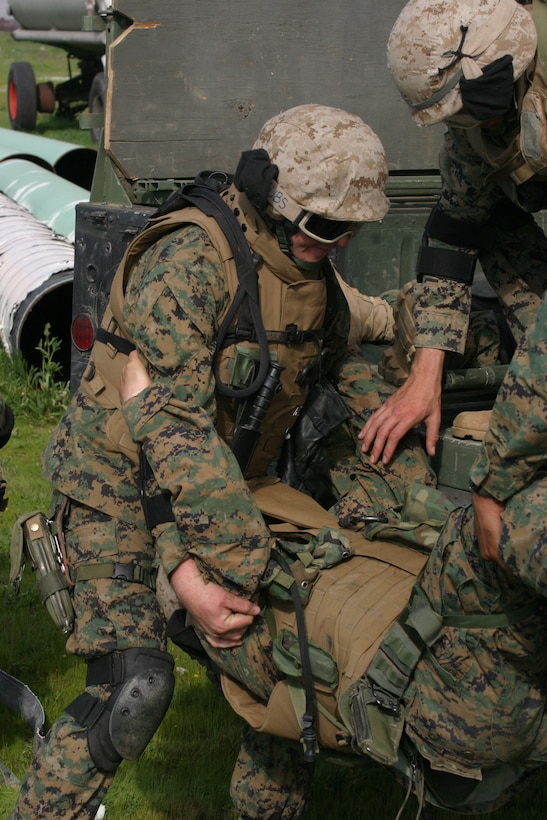 MARCH AFB MORENO VALLEY, Calif. (January 28, 2005)- Hospitalman Michael K. Ledbetter, a corpsman with 3rd Battalion, 2d Marine Regiment lifts an injured Marine onto a high mobility multi-wheeled vehicle during convoy operations training. The training was the last opportunity for the battalion to prepare for deployment to Iraq.