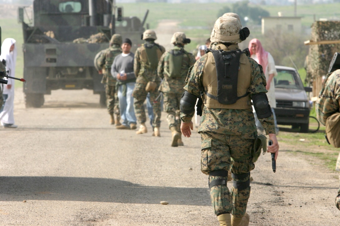 MARCH AFB MORENO VALLEY, Calif. (January 28, 2005)- Hospitalman Michael K. Ledbetter, a corpsman with 3rd Battalion, 2d Marine Regiment walks along a convoy through a ficticious Iraqi village during convoy operations training.