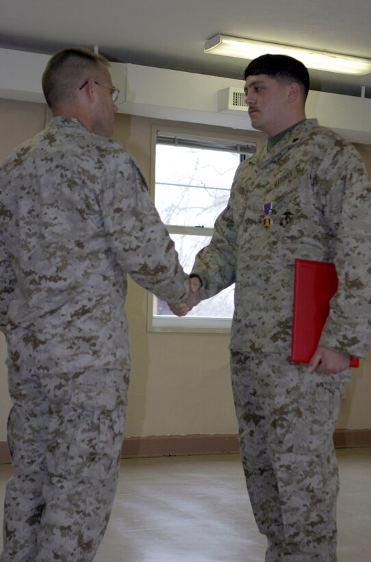 050228-M-2607O-002 MARINE CORPS BASE CAMP LEJEUNE, N.C. (February 28, 2005) -- Corporal Jason D. Schreiber, a field radio operator with 5th Battalion, 10th Marine Regiment, shakes hands with Col. Thomas L. Cariker, regimental commander, when he received his Purple Heart for being wounded in Iraq during Operation Iraqi Freedom.  Four months from now Schreiber will leave the corps to pursue other interests.
