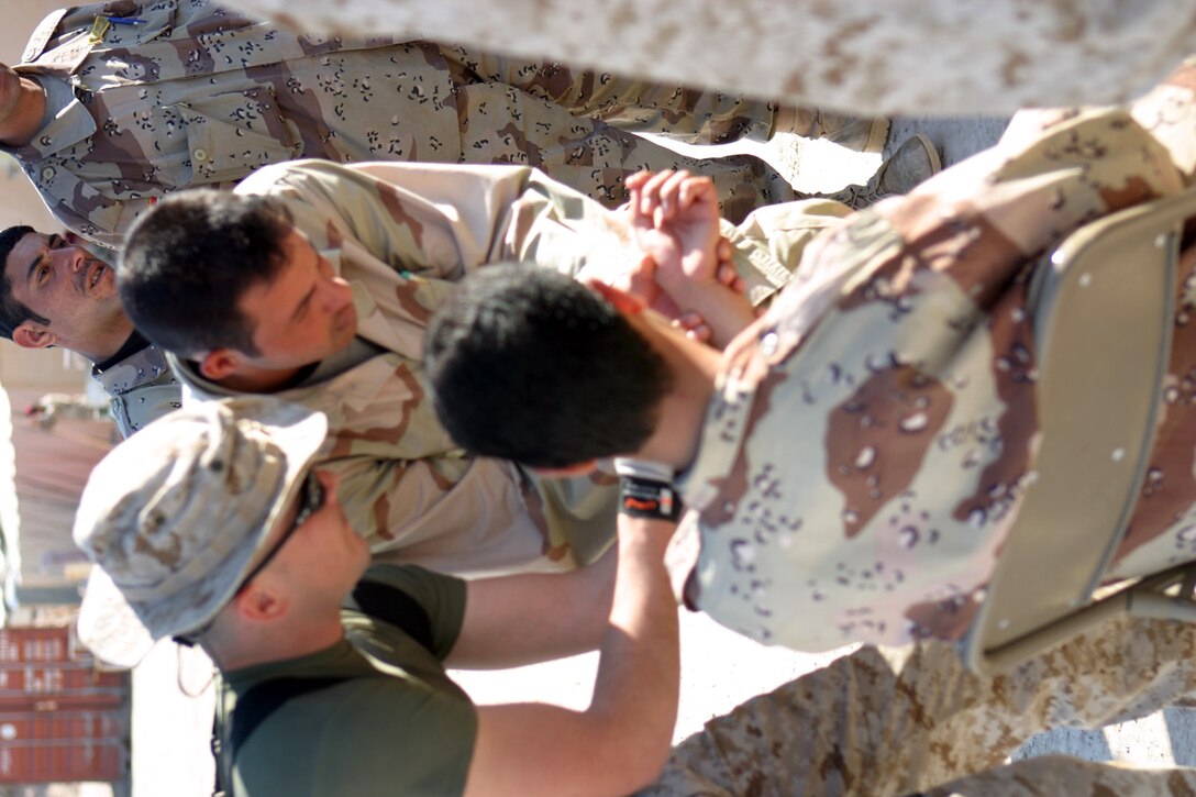 CAMP FALLUJAH, IRAQ – Petty Officer 3rd Class Shandon E. Torres shows ISF members how to properly check the pulse from the wrist.  The ISF members were taught the combat lifesavers course by two corpsmen and one doctor from the 3rd Battalion, 8th Marine Regiment Battalion Aid Station.  Official U.S. Marine Corps photo by Lance Cpl. Athanasios L. Genos