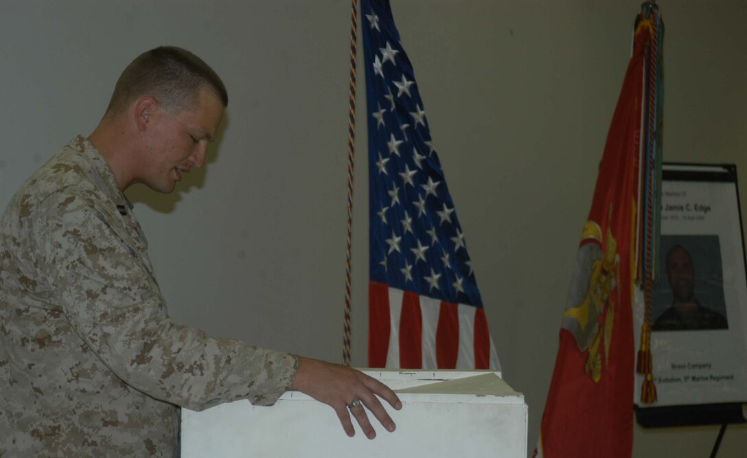 CAMP RAMADI, Ar Ramadi, Iraq (April 19, 2005) - Navy Lt. Aaron T. Miller, chaplain, 1st Battalion, 5th Marine Regiment, delivers the meditation during Capt. Jamie C. Edge's memorial ceremony, which was held in the dining facility here. Edge, a 32-year-old Marine leader from Virginia Beach, Va., and commanding officer for the infantry battalion's Company B, was killed by enemy fire while conducting a combat patrol with his men. He's best remembered for being hardworking, dedicated, professional and caring. Edge is survived by his wife, Krissy, and two daughters, Helena and Rachel. Photo by Cpl. Tom Sloan