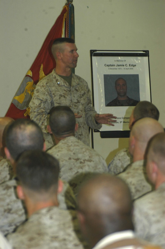 CAMP RAMADI, Ar Ramadi, Iraq (April 19, 2005) - Lieutenant Col. Eric M. Smith, commanding officer, 1st Battalion, 5th Marine Regiment, addresses service members who attended Capt. Jamie C. Edge's memorial ceremony, which was held in the dining facility here. Edge, a 32-year-old Marine leader from Virginia Beach, Va., and commanding officer for the infantry battalion's Company B, was killed by enemy fire while conducting a combat patrol with his men. He's best remembered for being hardworking, dedicated, professional and caring. Edge is survived by his wife, Krissy, and two daughters, Helena and Rachel. Photo by Cpl. Tom Sloan
