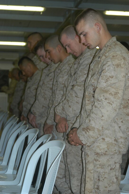 CAMP RAMADI, Ar Ramadi, Iraq (April 19, 2005) -Marines with 1st Battalion, 5th Marine Regiment, bow their heads in prayer during a memorial ceremony in honor of the late Capt. Jamie C. Edge, which was held in the dining facility here. Edge, a 32-year-old Marine leader from Virginia Beach, Va., and commanding officer for the infantry battalion's Company B, was killed by enemy fire while conducting a combat patrol with his men. He's best remembered for being hardworking, dedicated, professional and caring. Edge is survived by his wife, Krissy, and two daughters, Helena and Rachel. Photo by Cpl. Tom Sloan
