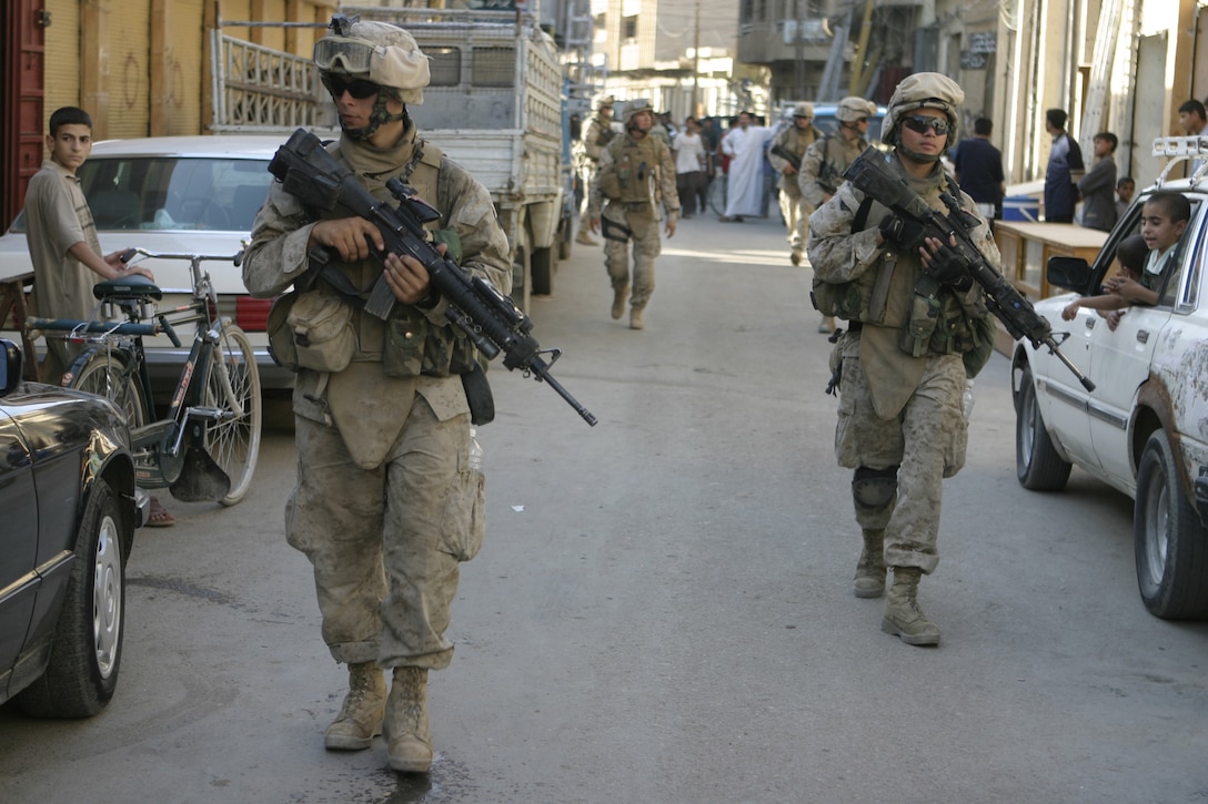 FALLUJAH, Iraq - Lance Cpl. Guido Filippone, a rifleman with 2nd Squad, 3rd Platoon, Company C, 1st Battalion, 6th Marine Regiment, patrols the city streets May 28 alongside his fellow infantrymen.  The 18-year-old West Palm Beach, Fla. native immigrated to the United States from Italy approximately six years ago, and now serves in the Marine Corps by helping Iraqi Security Forces provide security and stability to Fallujah's residents.