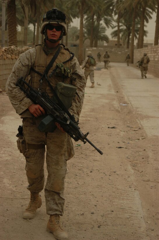 AR RAMADI Iraq (June 29, 2005) - Lance Cpl. Steven R. Seeley, a machine gunner with 3rd Squad, 4th Platoon, Company B, 1st Battalion, 5th Marine Regiment, patrols down a street in the city here with his comrades June 28. The 21-year-old from Beaverton, Ore., and his fellow Marines conducted a patrol through a portion of their company's area of operations to locate enemy sniper positions. Company B's observation post has been taking sporadic sniper fire from the area around it. Photo by: Cpl. Tom Sloan