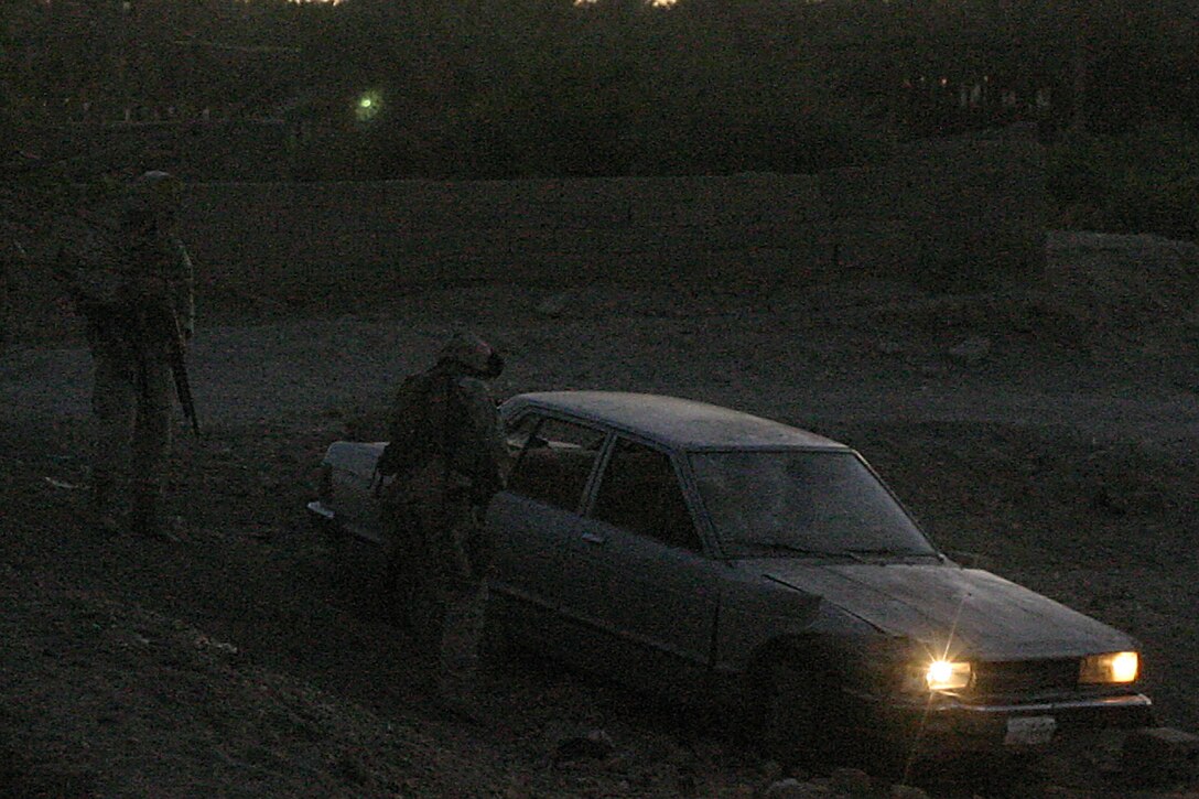Hit, Al Anbar, Iraq (June 28, 2005)-- Marines with 1st platoon, Lima Co., 3/25 search a car that was engaged as an SVBIED during Operation Sword. (Official USMC Photo by Corporal Ken Melton)