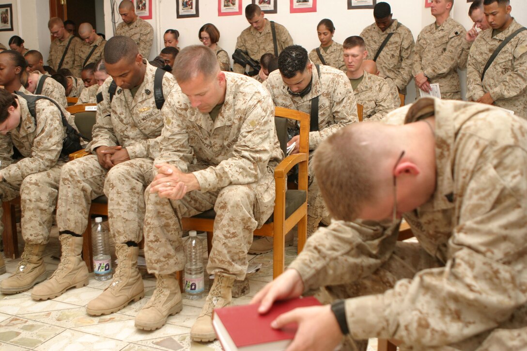 CAMP BLUE DIAMOND, AR RAMADI, Iraq - Major Craig P. Lambert, deputy communications officer, prays in the camp's chapel during a memorial service for Cpl. Ramona M. Valdez a 21-year-old field radio operator and member of the 2nd Marine Division's G-6 Communications section.  Valdez was killed in when a suicide car-bomber struck her convoy a few days earlier.  U.S. Marine Corps photo by Sgt. Stephen D'Alessio (RELEASED)