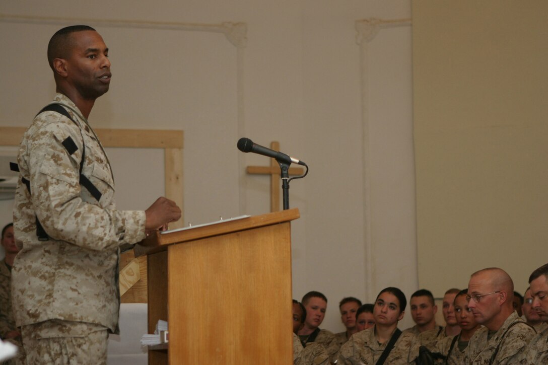 CAMP BLUE DIAMOND, AR RAMADI, Iraq -- Master Gunnery Sgt. Keith A. Sylvain, communication chief, speaks to gatherers in the camp's chapel during a memorial service for Cpl. Ramona M. Valdez a 21-year-old field radio operator and member of the 2nd Marine Division's G-6 Communications section.  Valdez was killed in when a suicide car-bomber struck her convoy a few days earlier.  U.S. Marine Corps photo by Sgt. Stephen D'Alessio (RELEASED)