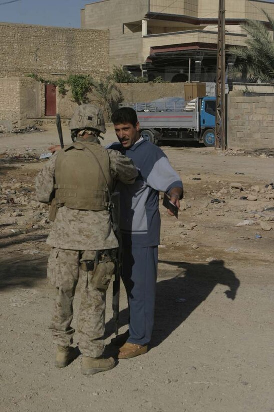 HIT, Iraq- (June 28, 2005) A Marine with 3rd Battalion, 25th Marine Regiment, Company L searches an Iraqi man during a sweep of the city of Hit during Operation Sword.  The operation was conducted to destroy insurgency leadership strong points.  The Marines of 2nd Marine Division conducted counter-insurgency operations with Iraqi Security Forces to isolate and neutralize anti-coalition forces.  U.S. Marine Corps photo Cpl. Eric C. Ely (RELEASED)