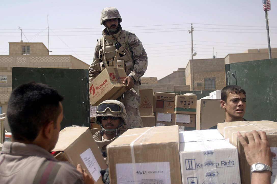 Hit, Al Anbar, Iraq (July 28, 2005)--Soldiers with Iraq Intervention Force hand out medical supplies to local hospital. (Official USMC Photo by Corporal Ken Melton)