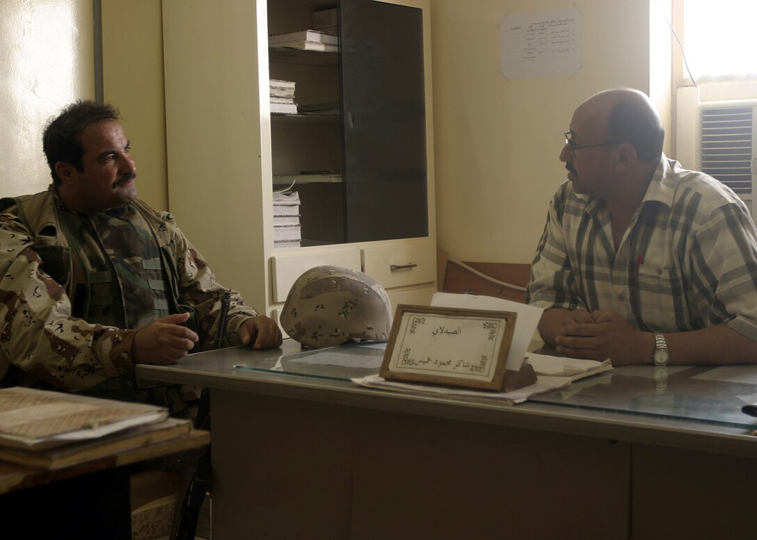 Hit, Al Anbar, Iraq (July 28, 2005)--Commanding officer of Company "1", Col. Mahdi A. Mohammed, a 39-year-old Mosul native speaks with the hospital administrator. (Official USMC Photo by Corporal Ken Melton)