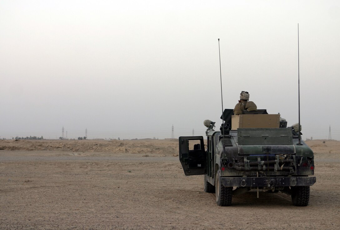 FALLUJAH, Iraq - Marines with 2nd Combined Anti-Armor Team, Weapons Company, 1st Battalion, 6th Marine Regiment observe the deserts around Route Mobile here Aug. 28 from aboard their High Mobility Multi-Wheeled Vehicle (HMMWV) while manning a temporary observation post.  Weapons Company Marines routinely observe this frequently transited supply route, which connects Baghdad and Fallujah, for insurgents emplacing roadside bombs.