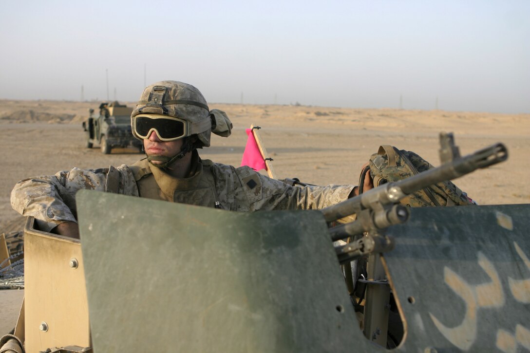 FALLUJAH, Iraq - Lance Cpl. Robert A. Belaire, an infantryman with 2nd Combined Anti-Armor Team, Weapons Company, 1st Battalion, 6th Marine Regiment, looks out at the horizon while manning a temporary observation post along Route Mobile here Aug. 28.  The 20-year-old Lafayette, La. native and his Weapons Company teammates routinely observe this frequently transited supply route, which connects Baghdad and Fallujah, for insurgents emplacing roadside bombs.