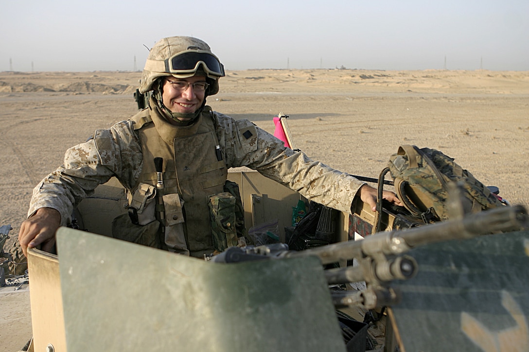 FALLUJAH, Iraq - Lance Cpl. Robert A. Belaire, an infantryman with 2nd Combined Anti-Armor Team, Weapons Company, 1st Battalion, 6th Marine Regiment, looks out at the horizon while manning a temporary observation post along Route Mobile here Aug. 28.  The 20-year-old Lafayette, La. native and his Weapons Company teammates routinely observe this frequently transited supply route, which connects Baghdad and Fallujah, for insurgents emplacing roadside bombs.