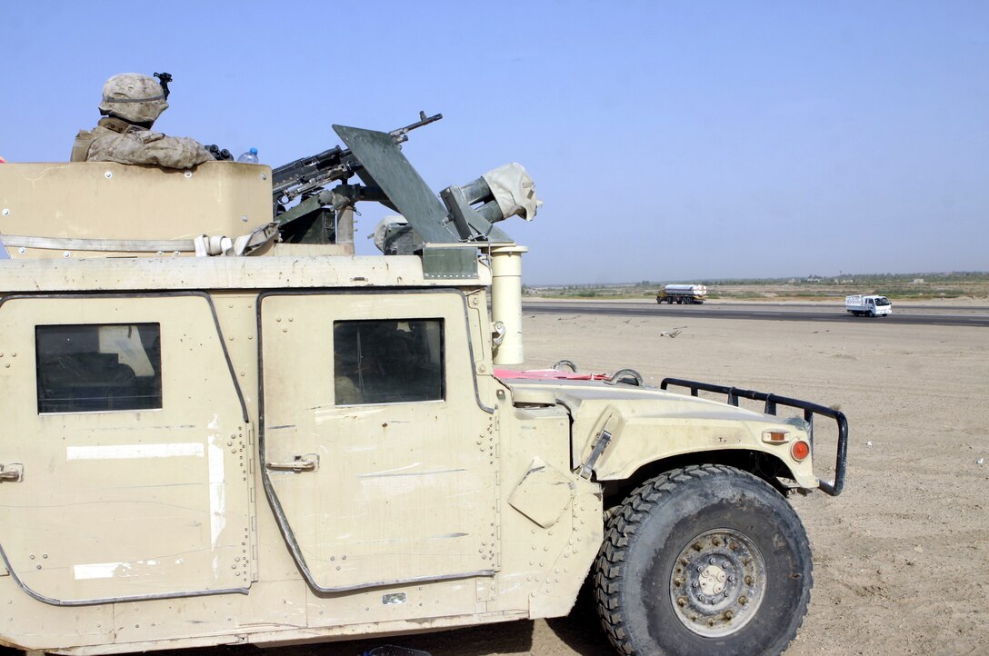 FALLUJAH, Iraq - An infantryman with 2nd Combined Anti-Armor Team, Weapons Company, 1st Battalion, 6th Marine Regiment, observes the deserts around Route Mobile here Aug. 28 from aboard his High Mobility Multi-Wheeled Vehicle (HMMWV) while manning a temporary observation post.  Weapons Company Marines routinely observe this frequently transited supply route, which connects Baghdad and Fallujah, for insurgents emplacing roadside bombs.