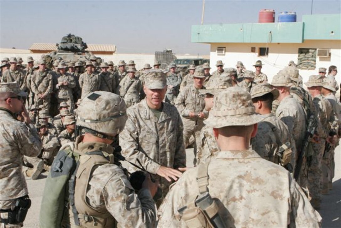 CAMP KOREAN VILLAGE, Iraq ? The Commandant of the Marine Corps, Gen. Michael W. Hagee, shakes hands with Marines after giving a motivational talk and answering questions from a group of Marines and Sailors during a stop at the camp Dec. 6. The 33rd Commandant of the Marine Corps and other high-ranking officials visited troops here and in small bases throughout western Iraq.